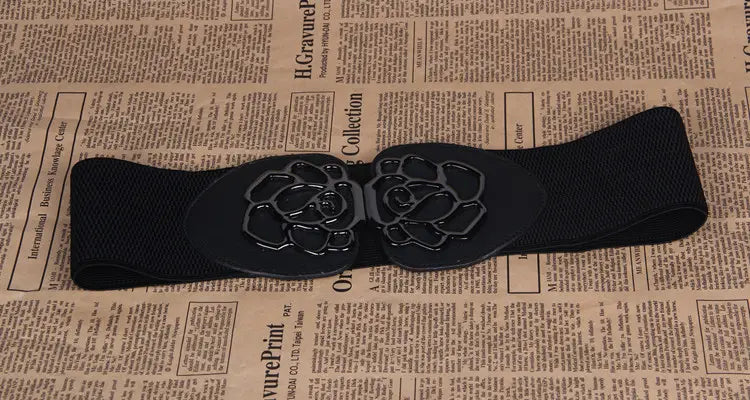 Black elastic belt featuring a floral buckle in the 3 Women’s Belts collection.