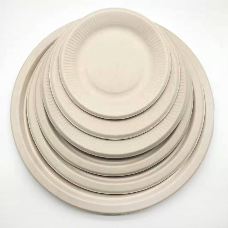 Stack of beige Pure Pulp disposable paper plates for eco-friendly serving solutions.