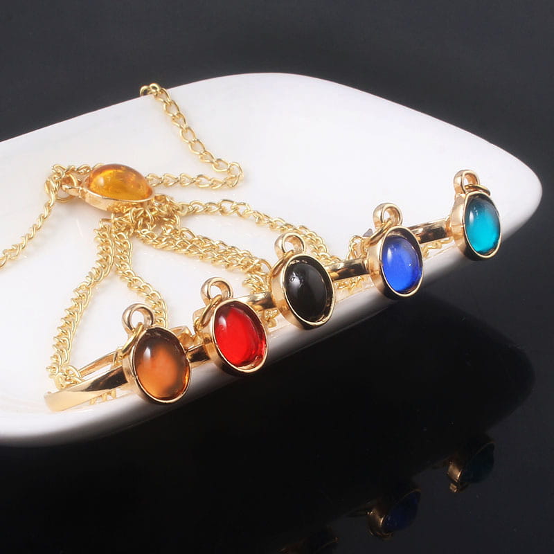 Gold-tone hand chain adorned with vibrant oval stones for women’s and girls’ jewelry.