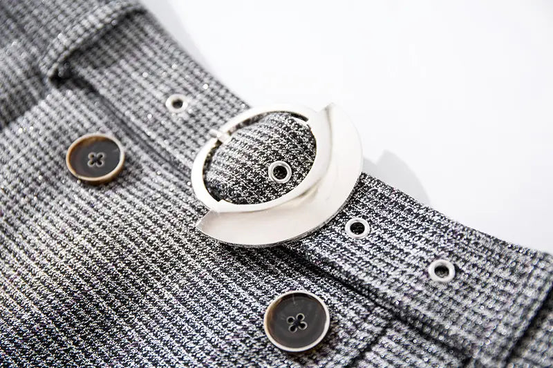 Gray and white patterned garment featuring silver buckle and brown buttons for women’s belts.