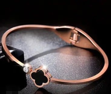 Rose gold four-leaf clover bangle in elegant open design for women’s jewelry.