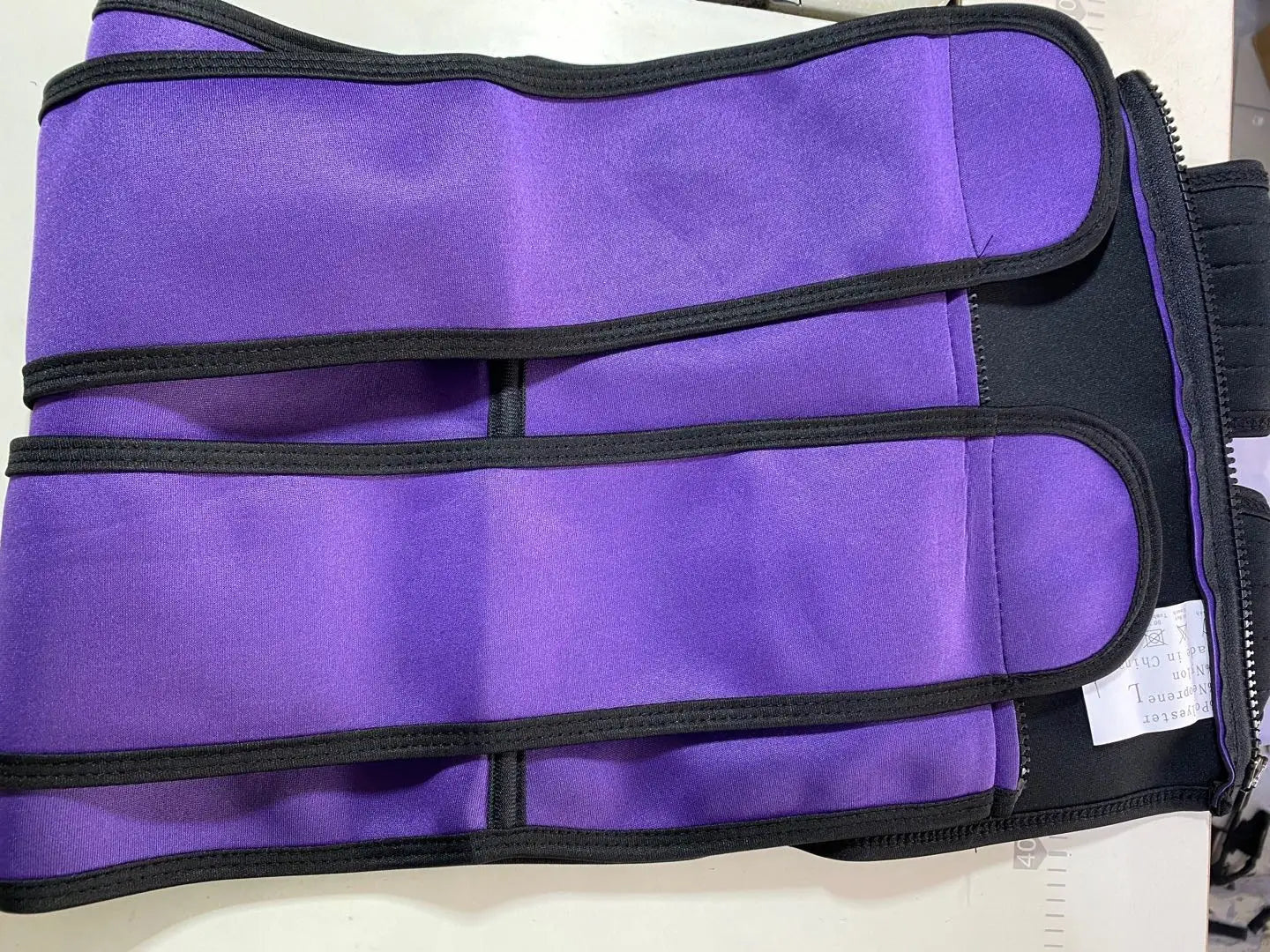 Purple waist trimmer with adjustable straps from The Sports Tuck Belts collection.