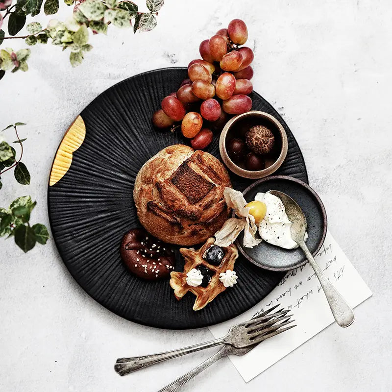 Artistic food platter showcasing Wujin Moyu Creative Tableware Set ceramic dishes.