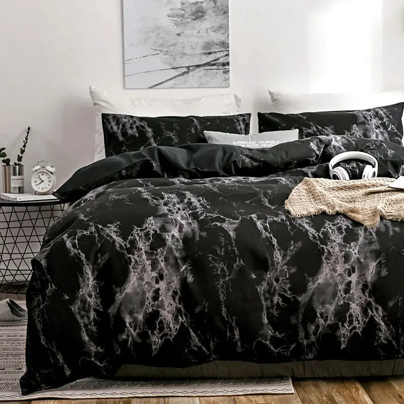 Black marble patterned bedding set including quilt, duvet cover, and pillow cases.