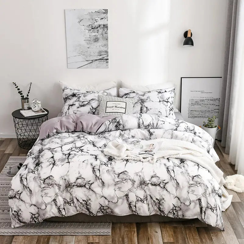 Marble-patterned bedding set featuring quilt, duvet cover, and pillow cases.