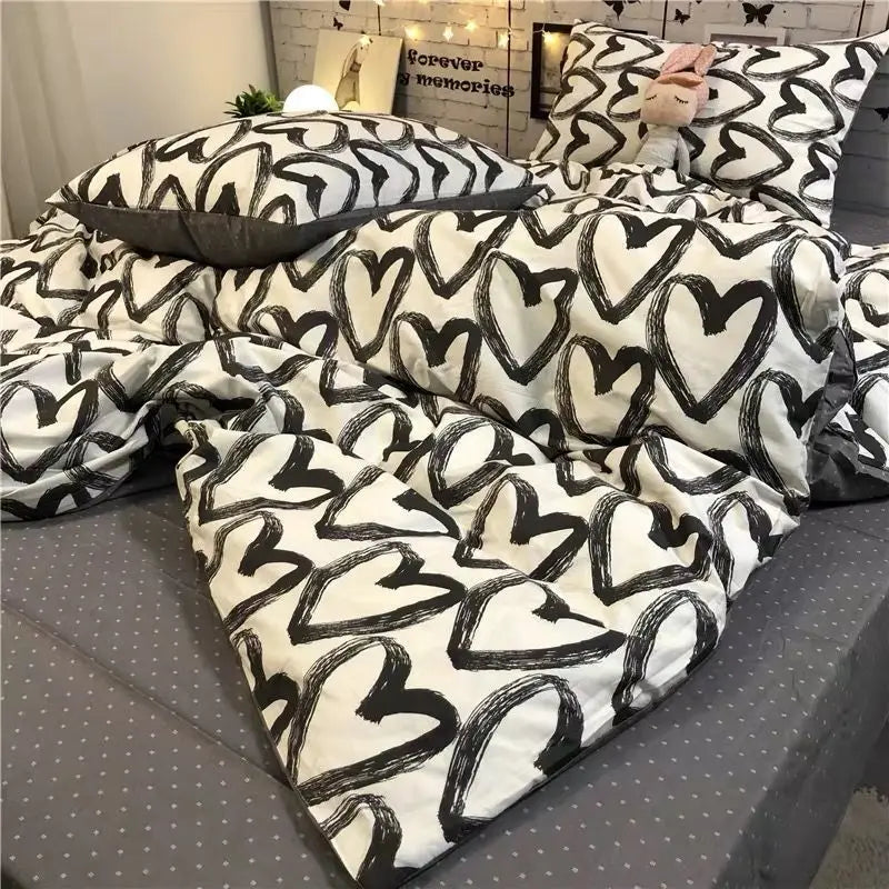 Heart-patterned bedding set in a three-piece set for a single bed in a student dormitory.