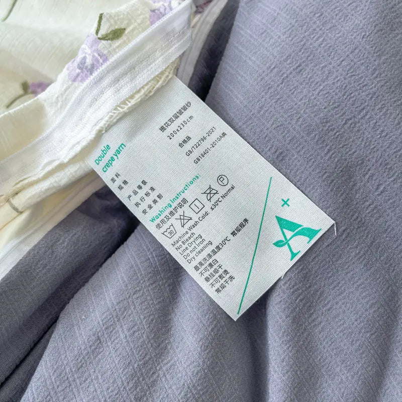 Fabric care tag for Four-piece Bed Set Jacquard Quilt Cover Sheets displayed prominently.