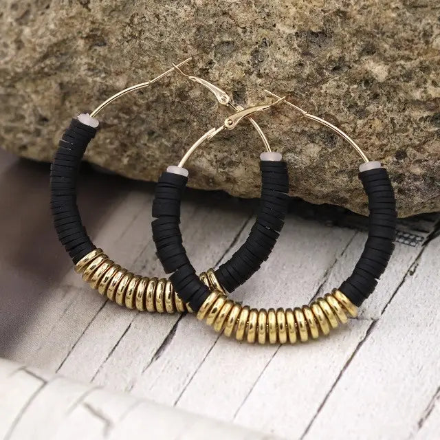Hoop earrings with black and gold beads in classic silver design for women.