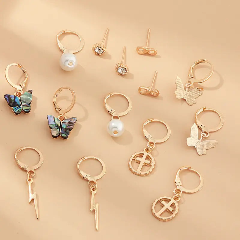 Assorted gold-tone earrings in Multi-Element Lightning Cross Small Earring Set.
