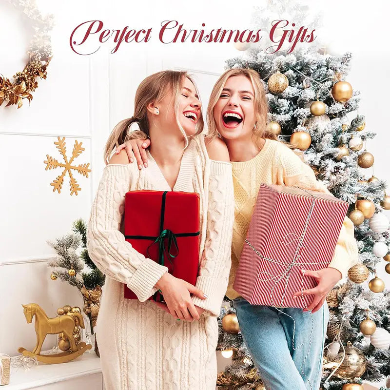 Two joyful women holding Christmas gifts beside a stylish insulated tumbler.