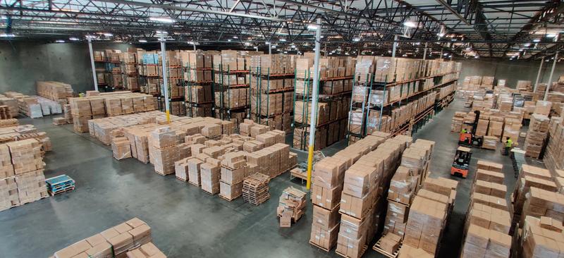 Warehouse filled with stacked boxes showcasing 40 Oz Tumbler With Handle Straw Insulated.
