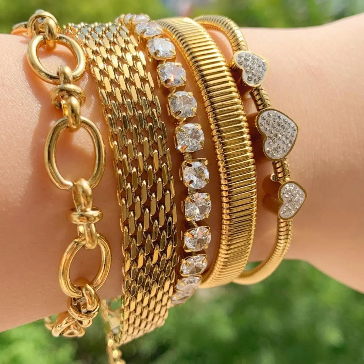 Stack of gold bracelets featuring Retro Set Silver Crystal Heart Shaped Women’s Jewelry.