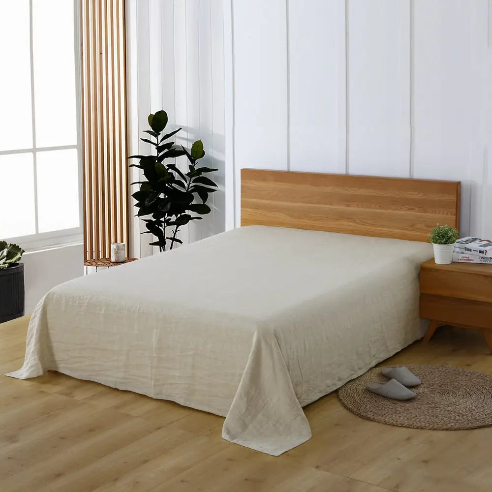 Beige bedspread on a bed showcasing Pure Linen Sheets for a luxurious bedroom aesthetic.