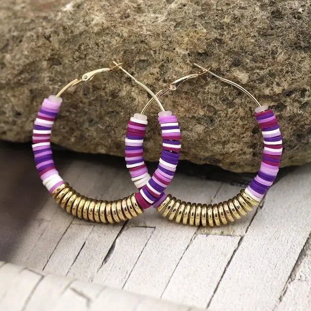 Hoop earrings adorned with colorful and gold beads, showcasing elegant design for women.