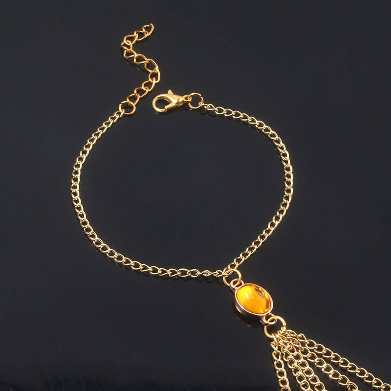 Gold-toned chain bracelet featuring an amber-colored stone for women’s jewelry.