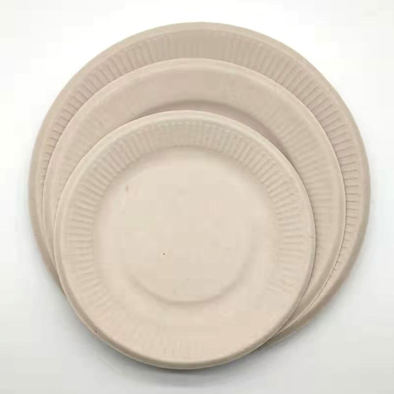 Stack of beige Pure Pulp disposable paper plates for eco-friendly serving solutions.