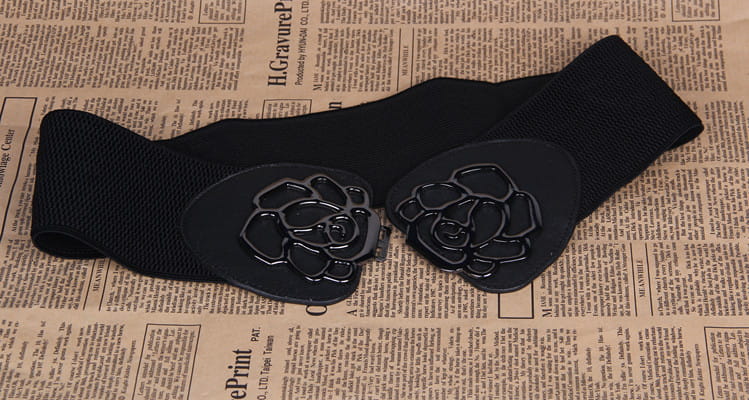 Black elastic belt featuring a floral buckle from the Women’s Belts collection.