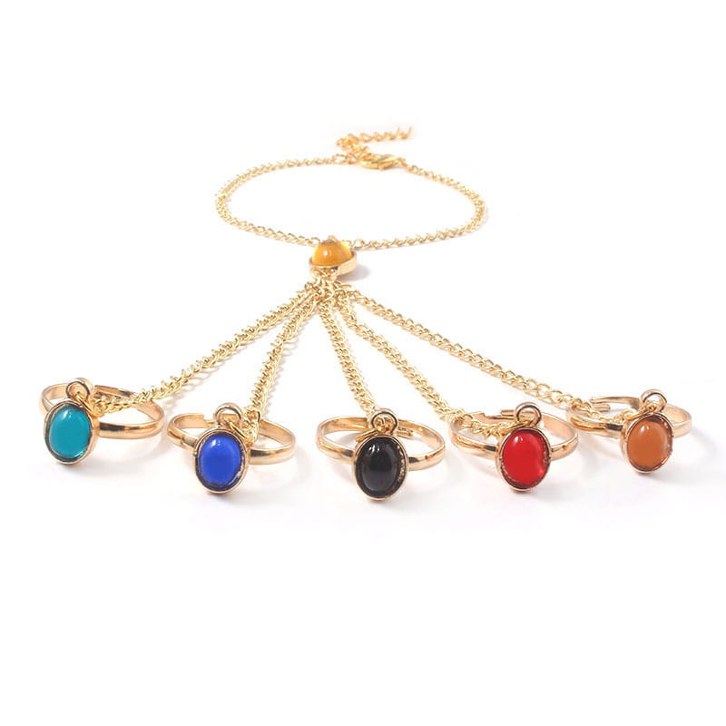 Gold-tone hand chain adorned with vibrant gemstone rings for women and girls’ jewelry.