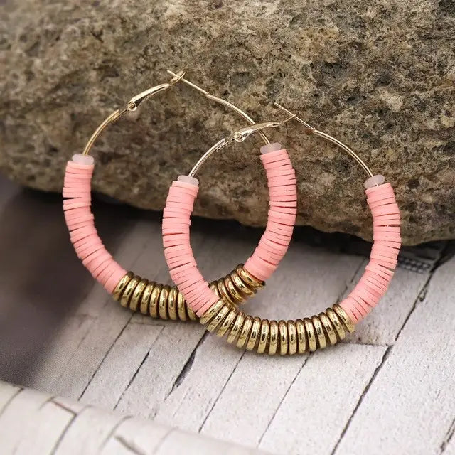 Pink and gold hoop earrings featured in classic women’s silver jewelry collection.