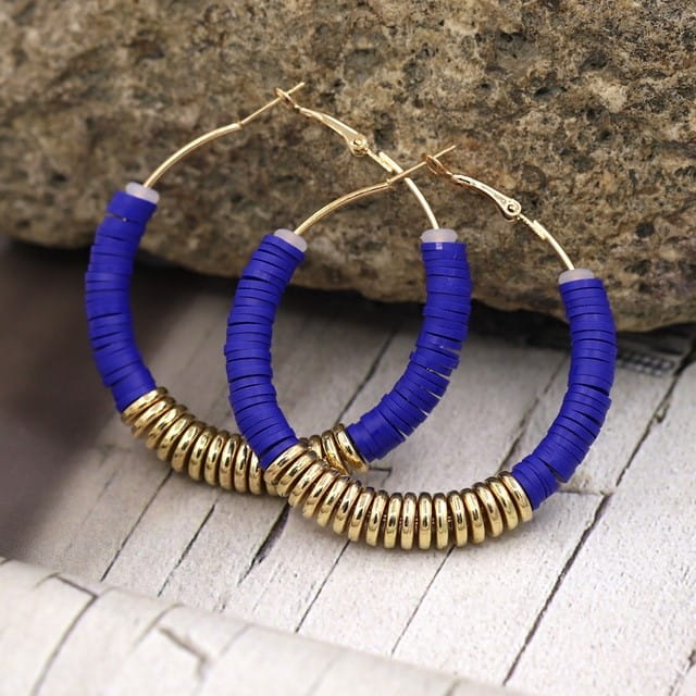 Blue and gold hoop earrings in classic silver design for women’s jewelry collection.