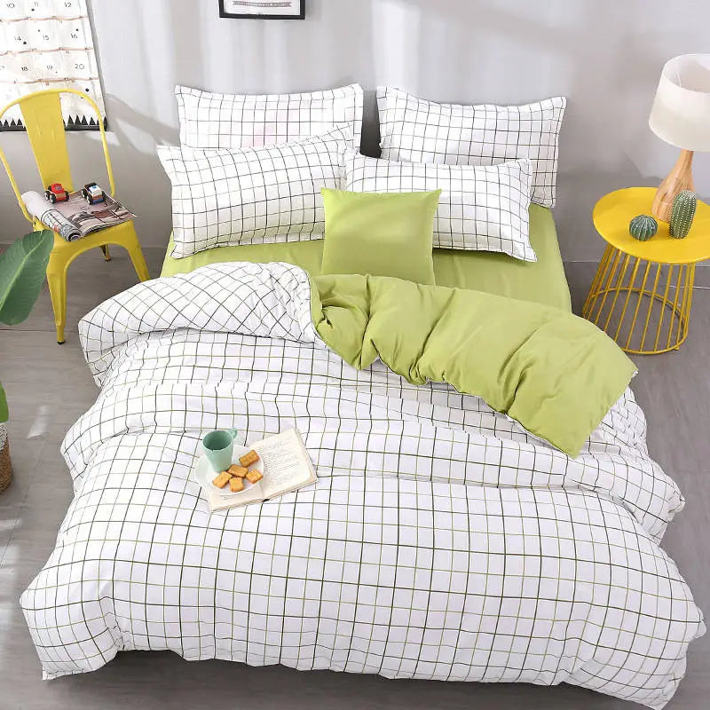 Cozy bed featuring checkered bedding and green accents in a Simple set of four sheets.