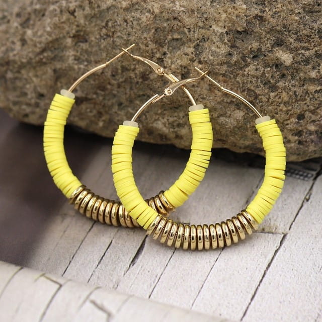 Yellow and gold hoop earrings featured in classic women’s jewelry collection.